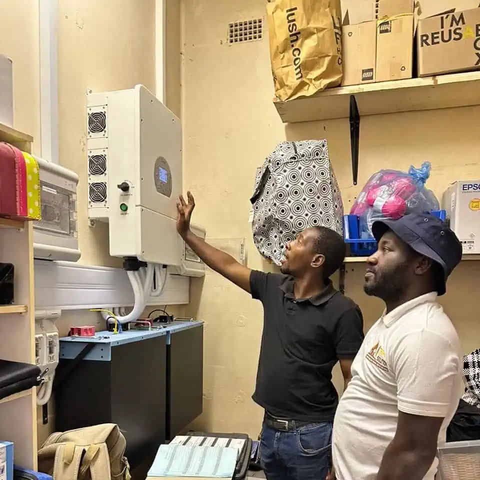 two men are looking at solar inverter